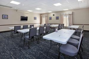 a conference room with tables and chairs and a tv at Hampton Inn Marysville in Marysville