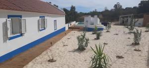 a house on the beach with plants in the sand at Monte da Venda de Baixo in Santa Margarida da Serra