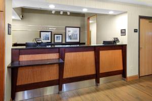 a lobby with a waiting room with a phone counter at Hampton Inn Portage in Portage +13 photos