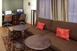 a living room with a couch and a table at Hampton Inn Portage in Portage