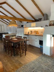 a kitchen with a wooden table and a dining room at Monte da Venda de Baixo in Santa Margarida da Serra