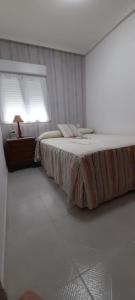 una camera da letto con un letto grande con una finestra di LA CASITA SERRANA a Puerto de Béjar