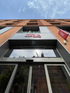 a building with a sign on the side of it at Aparthotel Adagio Original Toulouse Centre La Grave in Toulouse