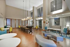 a lobby with tables and chairs and a cafeteria at Hampton Inn & Suites Childress in Childress
