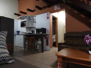 a kitchen and living room with a couch and a table at African Kruger Lodge in Marloth Park