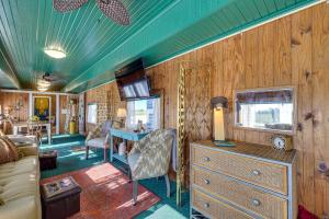 a living room with a couch and a table in a room at Charming Converted Railcar Studio in Joplin! in Joplin