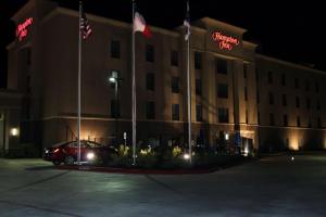 a car parked in front of a hotel at night at Hampton Inn Cotulla in Cotulla