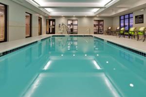 a swimming pool with blue water in a building at Hampton Inn Seneca Falls in Seneca Falls
