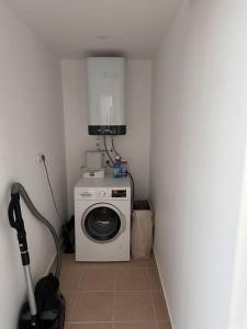 a laundry room with a washing machine in a corner at Havuzlu Sitede Müstakil Villa in Manavgat