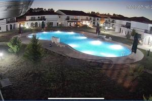 an overhead view of a swimming pool at night at Havuzlu Sitede Müstakil Villa in Manavgat