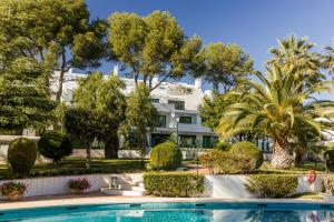 a resort with a swimming pool and palm trees at PENTHOUSE IN GOLDEN MILE in Marbella