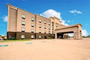 a large building with a parking lot in front of it at Hampton Inn Belton/Kansas City in Belton
