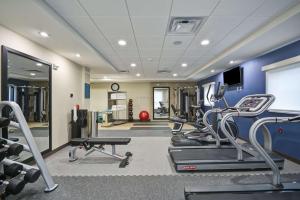 a gym with treadmills and machines in a room at Home2 Suites By Hilton Maumee Toledo in Maumee