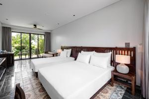 Ein Bett oder Betten in einem Zimmer der Unterkunft Coco Island Resort Ninh Binh