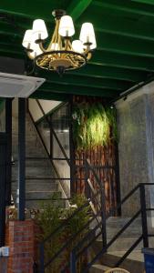 a staircase with a chandelier in a building with a staircase at DoSomething Guest House 5 in Ipoh