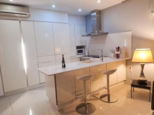 a kitchen with a counter with a bottle of wine on it at Modern Townhouse Ocean Front in Adeje