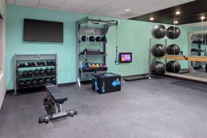 a room with a gym with a television and weights at Tru By Hilton Crossett in Crossett