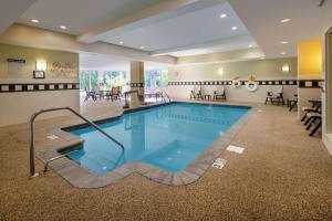 a large swimming pool in a hotel room at Hilton Garden Inn Mystic/Groton in Groton