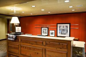 a lobby with a reception counter in a building at Hampton Inn & Suites Tifton in Tifton