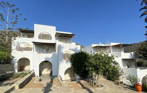 a white building with a tree in front of it at Apaggio Apartments in Katapola