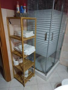 a glass shelf with towels on it in a bathroom at La Casa di Elisa in Cagliari