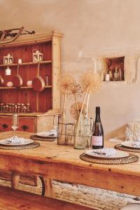 a table with two plates and a bottle of wine at Lammas Retreat in Minchinhampton in Minchinhampton