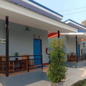 a home with a porch with a blue door at หม่อนเมือง รีสอร์ท in Chiang Rai