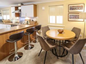 a kitchen with a wooden table and chairs at 10 Mellor Way in Grimsby