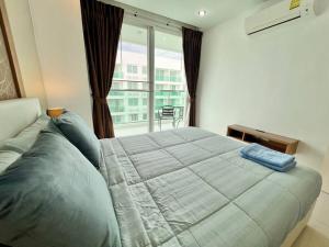 a bedroom with a large bed and a balcony at Blissful 1 Bed in Amazon Condo in Jomtien Beach +15 photos