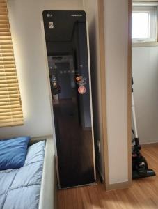 a black elevator in a room next to a bed at Doldamine Jeju in Jeju