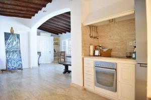 a kitchen with a stove top oven in a room at Chez Le Goff in Hydra