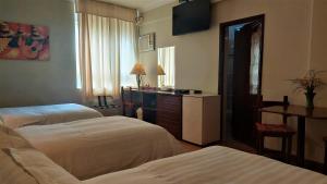 A bed or beds in a room at Lima Wasi Hotel Miraflores
