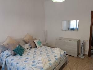 a bedroom with a bed and a dresser and a television at La Vista Storica in Piombino