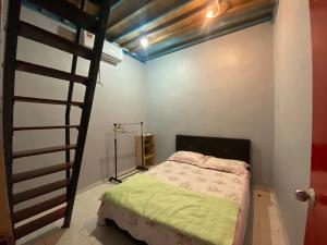 ein Schlafzimmer mit einem Etagenbett und einer Leiter in der Unterkunft Best Homestay in Kuala Rompin