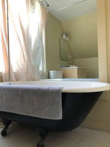 a bath tub with a towel on it in a bathroom at Modern Cottage Two (The Lorca, Catskills) in Shandaken