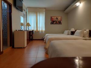 A bed or beds in a room at Lima Wasi Hotel Miraflores