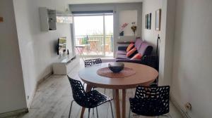 a small living room with a table and chairs at Beachfront Apartment with Sea Views & Private Parking in San Pol de Mar