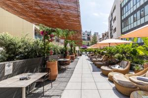 an outdoor patio with tables and chairs and plants at Catalonia Ramblas 4* Sup in Barcelona