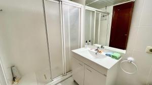 a white bathroom with a sink and a shower at Wallada Vistalegre in Córdoba +37 photos