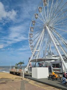 a ferris wheel on a pier next to the beach at Modern Family Caravan with WiFi at Valley Farm, Clacton-on-Sea in Great Clacton