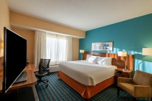 a hotel room with a bed and a flat screen tv at Fairfield Inn Richmond Chester in Chester