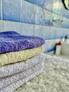 a stack of towels sitting on a counter in a bathroom at Kuća za odmor Bilić 