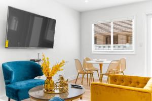 a living room with a tv and a table and chairs at 316 Footloose #3 in Hollywood
