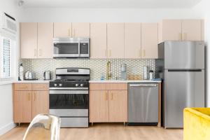 a kitchen with white cabinets and stainless steel appliances at 316 Footloose #3 in Hollywood