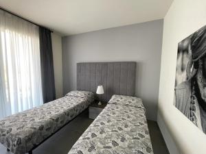 a hotel room with two beds and a window at Polinesia 5 in Lido delle Nazioni +16 photos