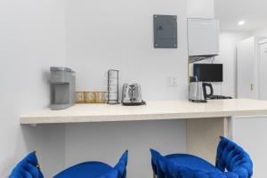 a counter with blue chairs in a room at 316 Footloose #1 in Hollywood