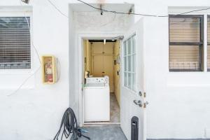 a laundry room with a washer and dryer next to a door at 316 Footloose #1 in Hollywood +22 photos