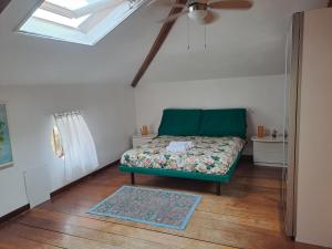 Cette chambre comprend un canapé vert et un ventilateur de plafond. dans l'établissement La Casetta Di Alfonso, à Santa Marinella