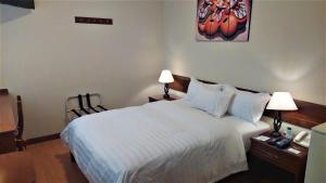 A bed or beds in a room at Lima Wasi Hotel Miraflores