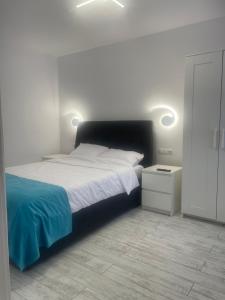 a bedroom with a large bed and a night stand at Casa Anita in Sighişoara